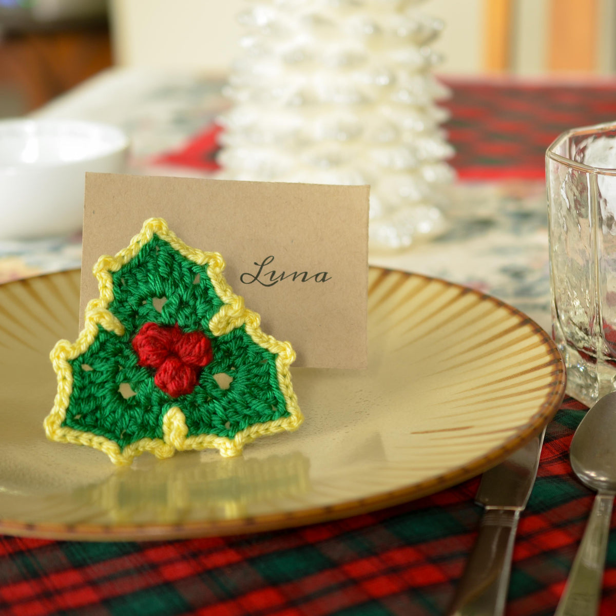Crochet Christmas Holly place card holder. Green and yellow crocheted holly leaf with red berries.