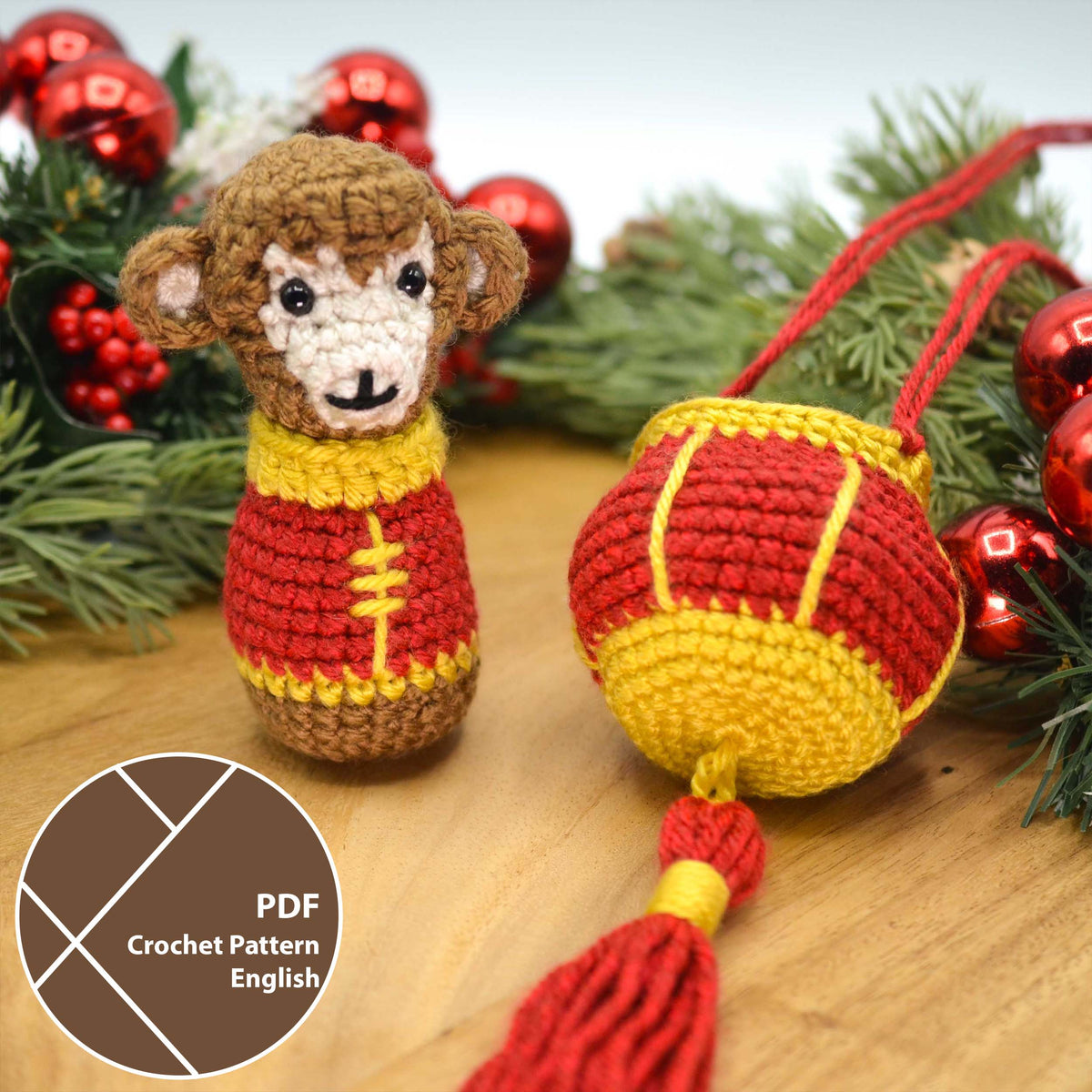 A crocheted monkey, wearing Lunar-New-Year clothing, is sitting on a wooden surface. A crocheted red lantern is next to the monkey. A label in the lower left corner indicates that this listing is a crochet pattern PDF that is written in English.