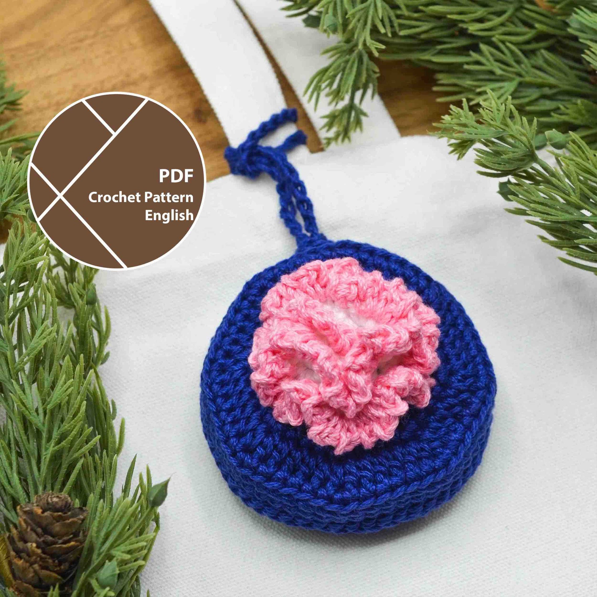 A crochet pattern for a bag charm, featuring January's birth month flower, Carnation. The charm is hanging on a canvas bag.