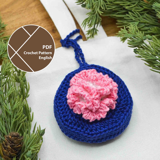 A crochet pattern for a bag charm, featuring January's birth month flower, Carnation. The charm is hanging on a canvas bag.