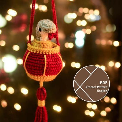 a crocheted snake in a red lantern