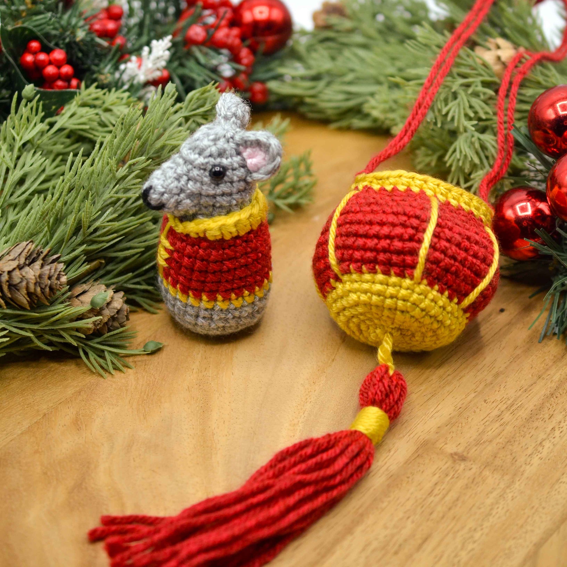 crocheted mouse and red lantern displayed on a wooden surface. The set is a lunar new year ornament. 