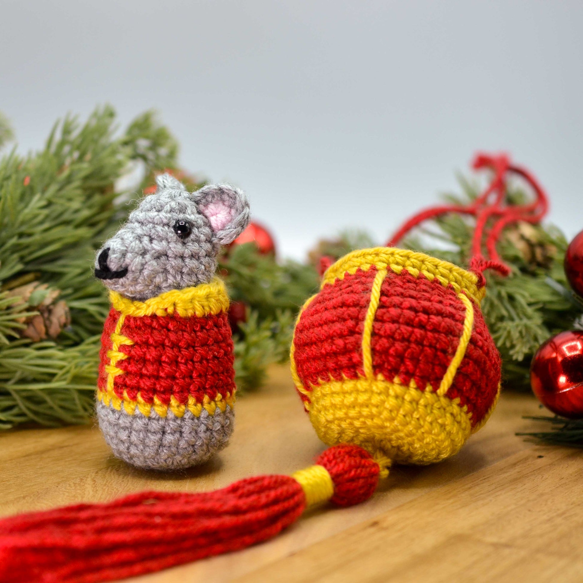 crocheted mouse and red lantern displayed on a wooden surface. The set is a lunar new year ornament.