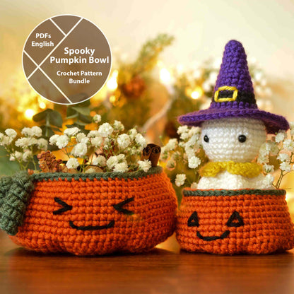 Crochet pattern for making a Halloween ghost amigurumi and two pumpkin bowls. The ghost is wearing a purple witch's hat and sitting in the smaller-size pumpkin bowl. The larger-size pumpkin bowl is holding potpourri and some baby's breath flowers. 