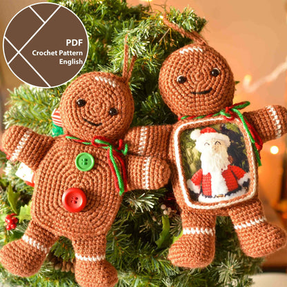 Two crocheted gingerbread man ornaments. One gingerbread man has a green and red ribbon and the other has a picture frame with a crocheted Santa Claus inside.
